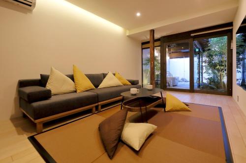 a living room with a couch and a table at Kyo no oozora FUKA in Kyoto