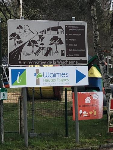 a sign in front of a park with a building at « En toute simplicité chez Fabienne et Bruno » in Waimes