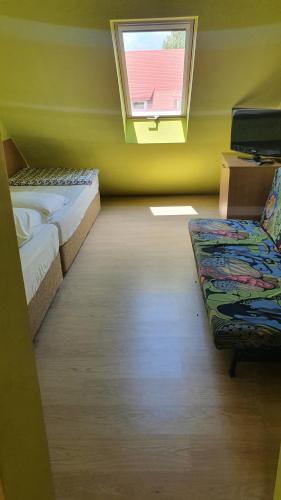 a room with two beds and a window at Sunshine SH apartmanház in Zamárdi
