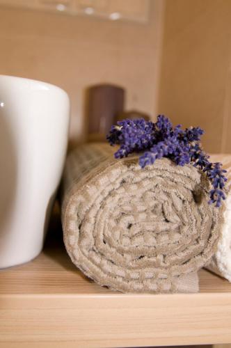 a cookie sitting on a table next to a cup at Garni Appartement Alpenresidence in Cadipietra