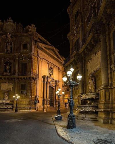 a building with a street light in front of it at night at B&B D'Amari Affittacamere in Palermo