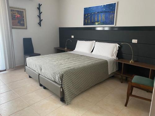 a bedroom with a large bed and a desk at Amici in Càbras