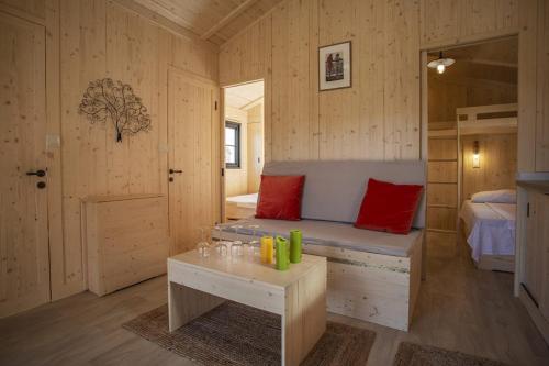 a small room with a bed and a table in it at Camping belle rivière in Chaniers