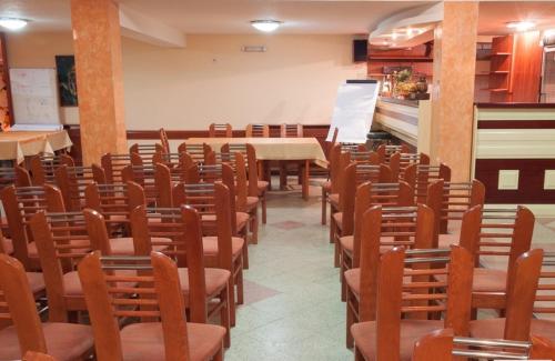a room with rows of chairs and a table at Hotel Ilinden in Strumica