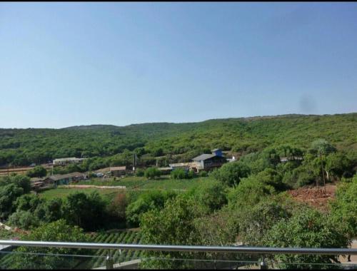 a view of a hill with a house on it at Suman Cottage & Bungalow in Mahabaleshwar