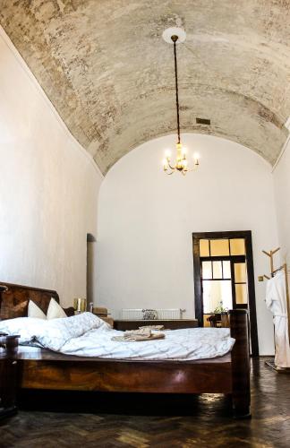 a large bed in a room with a ceiling at Roth´s Apartment in Košice
