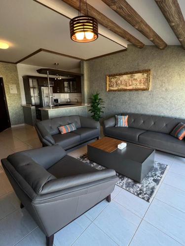 a living room with couches and a couch and a table at فندق قوافل الشام in Tabuk
