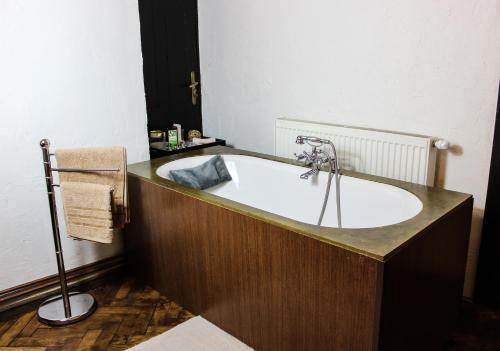 a bath tub in a bathroom with a sink at Roth´s Apartment in Košice