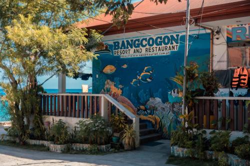 a surfboard sits in front of a building at Island Front - Bangcogon Resort and Restaurant in Oslob