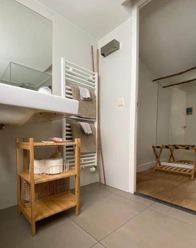 a room with a bunk bed and a mirror at Romantic Wellness BnB Noordwijk in Noordwijk aan Zee
