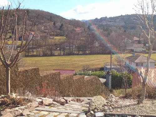 einen Regenbogen über einem Feld mit einem Haus in der Unterkunft Logement de charme in Coinches