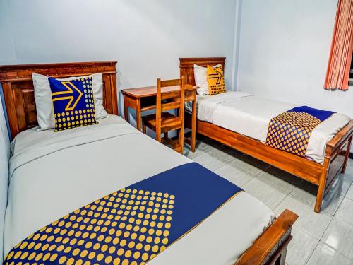 Katil atau katil-katil dalam bilik di SPOT ON 90797 Sukun Syariah Homestay