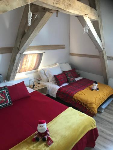 a bedroom with two beds with a santa claus on them at Bblodges Loches Beauval in Saint-Hippolyte