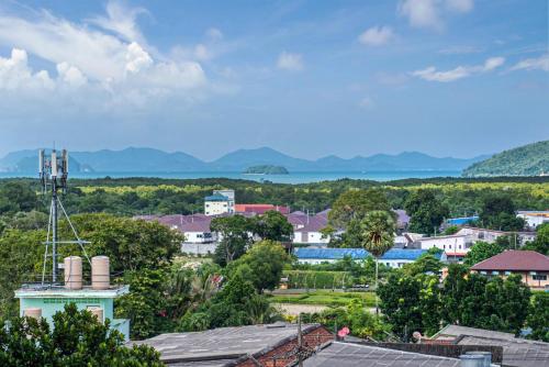 a view of a town with mountains in the background at Angel Pool Villa Phuket - SHA Extra Plus in Phuket Town