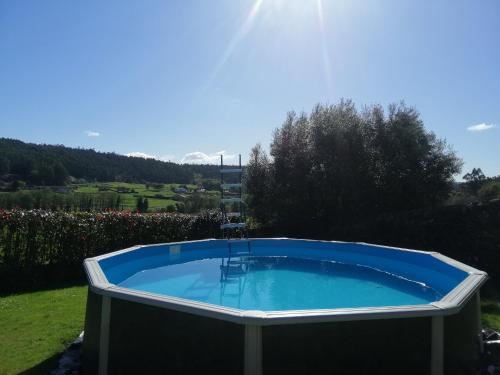 a hot tub in a yard with a view of a field at Casa Reibon in Santiago de Compostela
