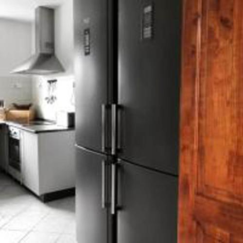 a stainless steel refrigerator in a kitchen at Villa Alexandra Szentantalfa in Szentantalfa