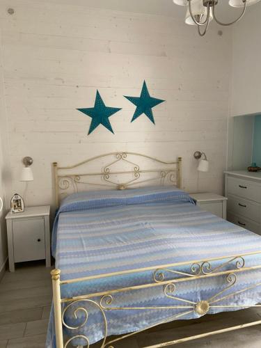 a bedroom with a bed with blue stars on the wall at Casetta Azzurra in Monopoli
