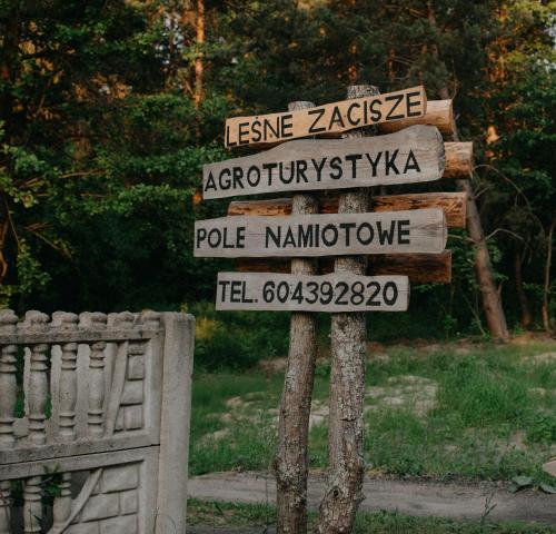 a street sign with several signs on it at Na Piaskach Agroturystyka Domek pod Lipą in Narol