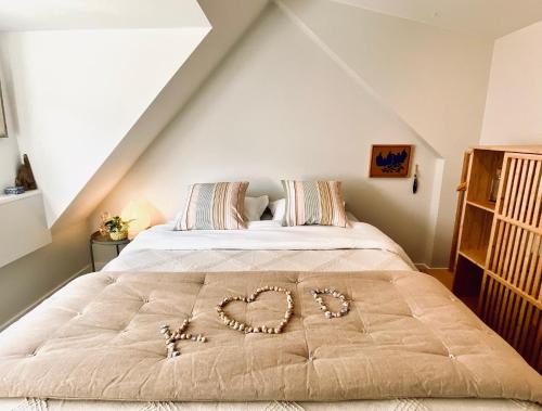 a bed with a heart drawn on it in a bedroom at Romantic Wellness BnB Noordwijk in Noordwijk aan Zee