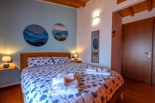 a bedroom with a bed with two towels on it at Happy Guest Apartments - Lake & Green Oasis in Riva di Solto