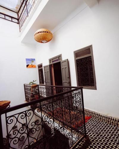 a balcony with a black railing and a ceiling at Boho 27 Hostel Marrakech in Marrakech