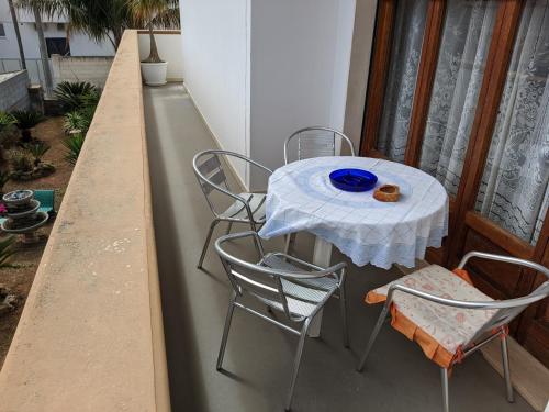 a table and four chairs on a balcony at casetta nel salento in Racale