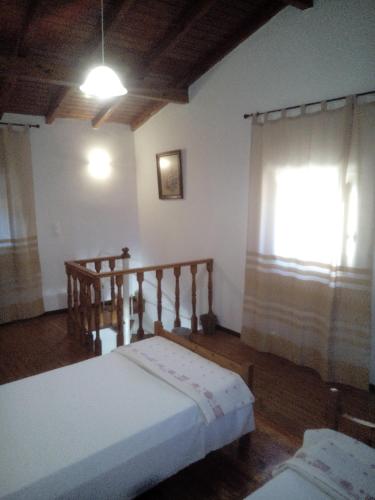 A bed or beds in a room at Traditional House with Loft -Michalis' House in Kouramades-