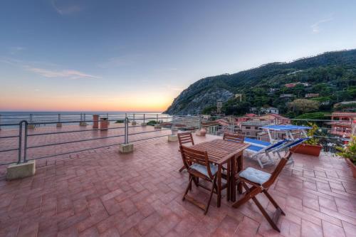 a patio with a table and chairs and the ocean at Poseidon Apartment 011019-LT-0180 in Monterosso al Mare