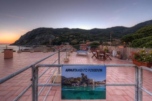 a sign on a railing with a view of the ocean at Poseidon Apartment 011019-LT-0180 in Monterosso al Mare
