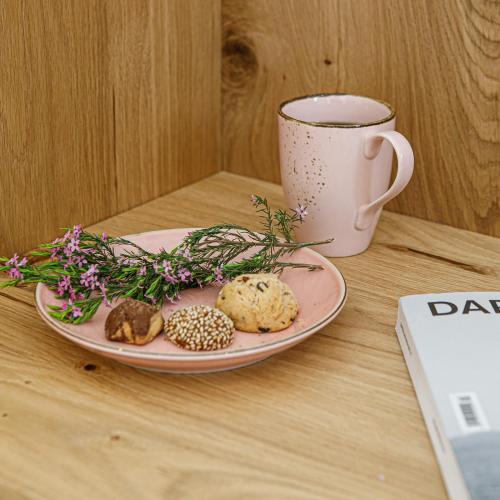 a plate of cookies and a cup of coffee on a table at Alio Naxos Luxury Suites in Agios Georgios