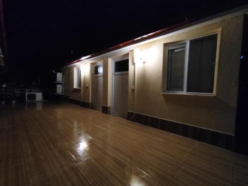 an empty room with a wooden floor and lights at Karaca Apart Hotel in Dalyan