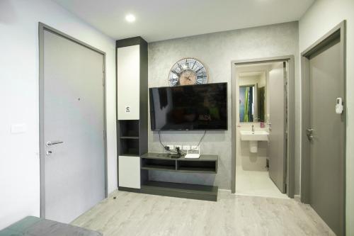 a living room with a flat screen tv on a wall at The Base Central apartments in Pattaya Central