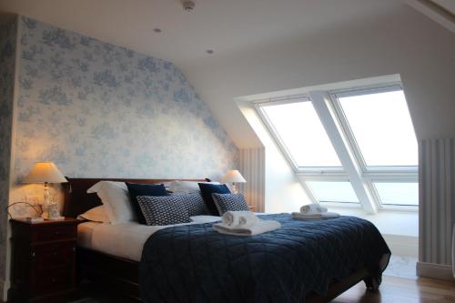a bedroom with a bed with two towels on it at Inch Beach House B&B in Inch