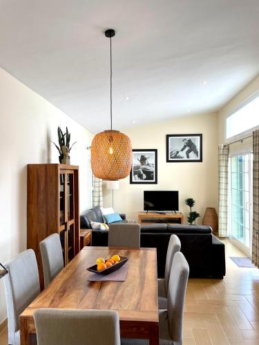 a living room with a table and a couch at Villa Jordi - Cala en Porter in Cala'n Porter