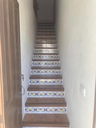 a stairway with a set of stairs with floral tiles at Can Che in Cala Galdana