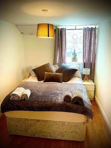 a bedroom with a large bed with two towels on it at T-post guest house in South Milford