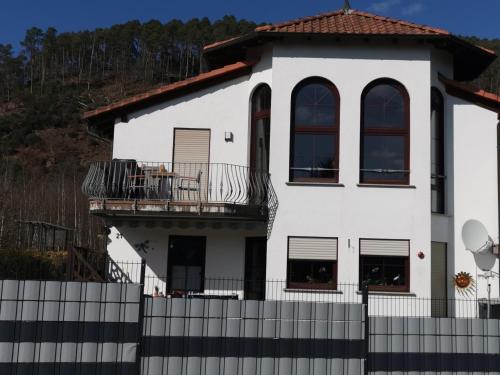 a white house with a fence in front of it at Ferienwohnung Burgpanorama in Dahn