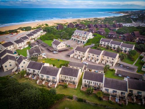 an aerial view of a resort with a beach and houses at 41 Settler Sands, 39 West Beach Road, Port Alfred in Port Alfred