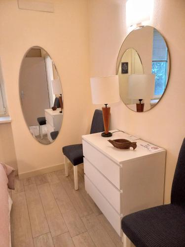 a bedroom with a white dresser and a mirror at Emerilla Home in bedizzol