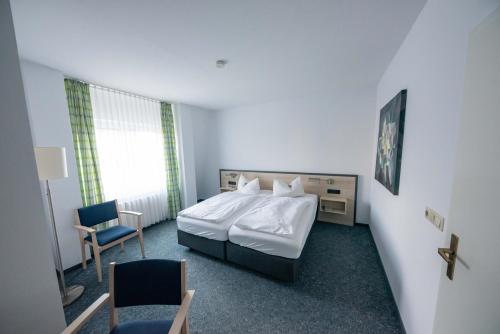 Una cama o camas en una habitación de Hotel 7 Säulen GmbH