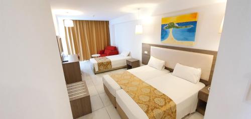 a hotel room with a bed and a couch at Corfu Hotel in Ayia Napa