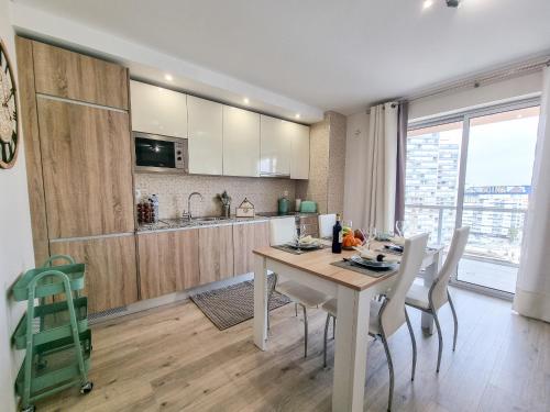 Una cocina y un comedor con mesa y sillas. en Elite Residente Gold 11, en Portimão