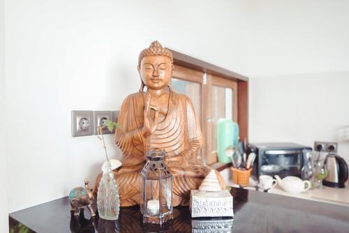 a statue of a buddha sitting on a table at Abinawa Hill in Lovina
