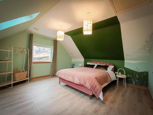 a bedroom with a bed with a green wall at Aite-Sithiel in Kingsburgh