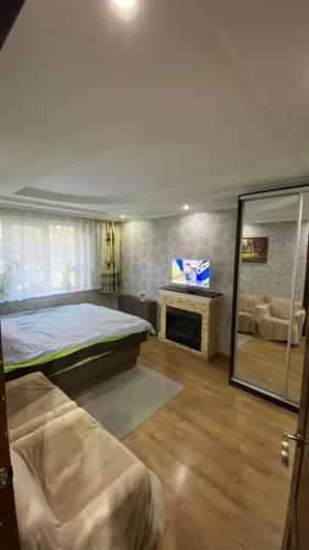 a bedroom with a large bed and a mirror at Квартира на Проспекті in Uzhhorod