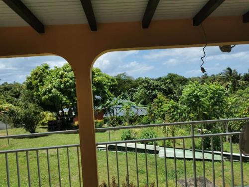a view from the balcony of a resort with trees at Chambres d'hôte dans la charmante commune de Ste Rose in Sainte-Rose