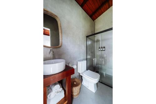 a bathroom with a sink and a toilet at Orixás Residence in Morro de São Paulo