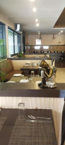 a restaurant with a counter with a counter top with a counter sidx sidx at Presidency Landmark in Daman