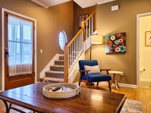 a living room with a table and a chair at Cozy House near Ole Miss & M-Trade! in Oxford