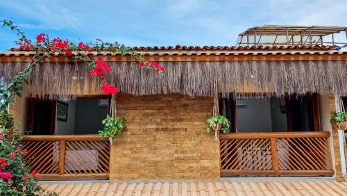 a house with flowers on the side of it at Acoara Beco Doce in Jericoacoara